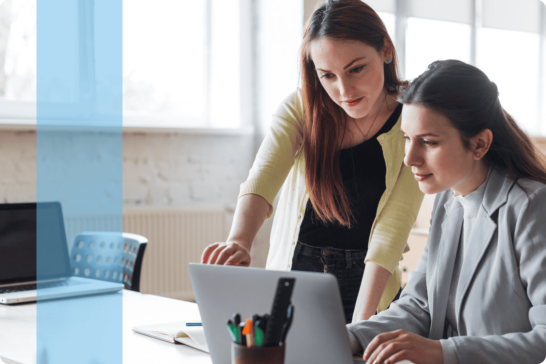 Two employees discussing in front of a laptop representing the Konnekt Generalist recruitment team.