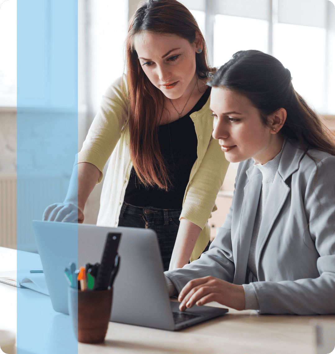 Two employees discussing in front of a laptop representing the Konnekt Generalist recruitment team.