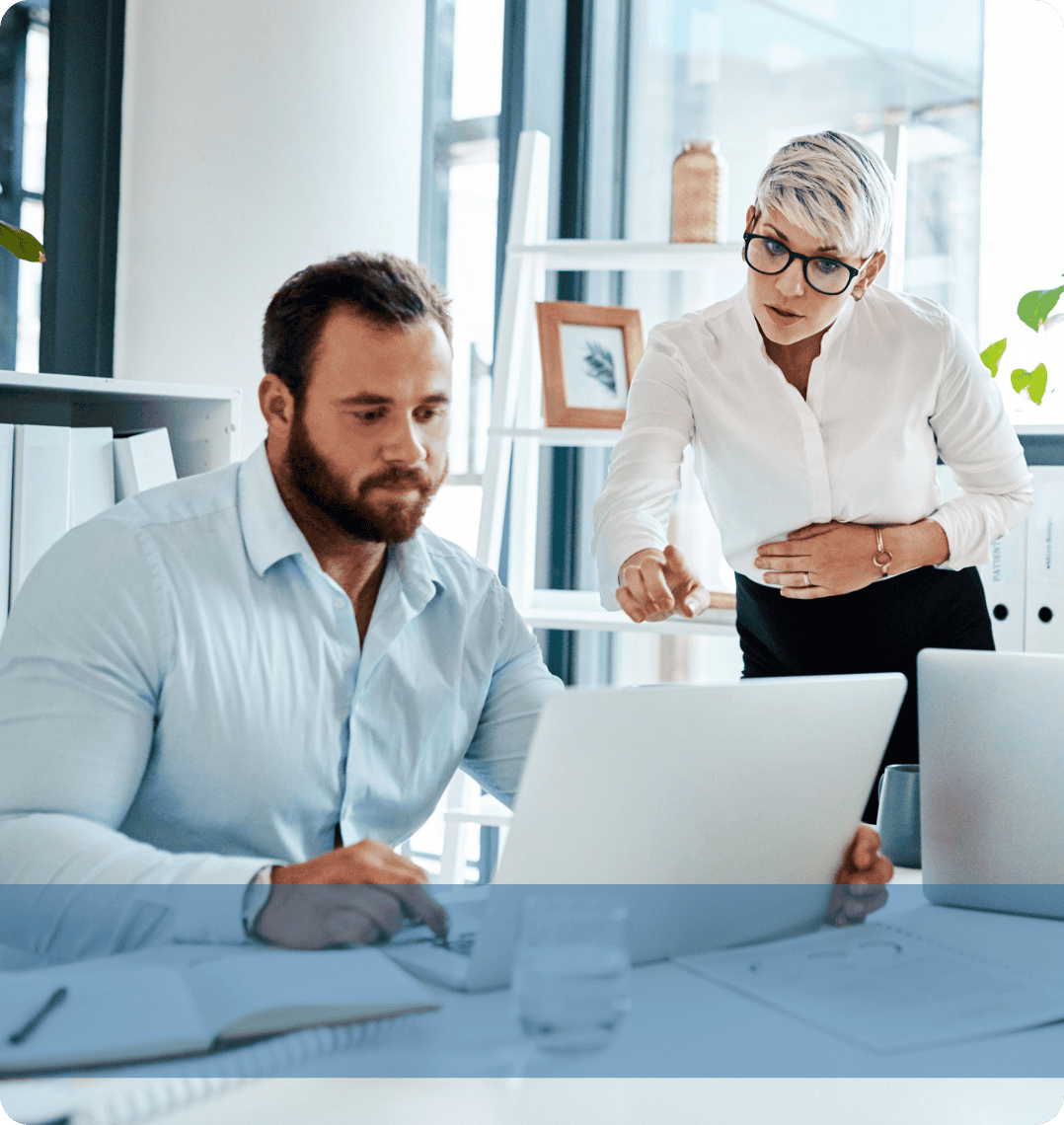 Two professionals engaging in a discussion at a desk, representing the Konnekt IT recruitment team analysing technical candidate pipelines.